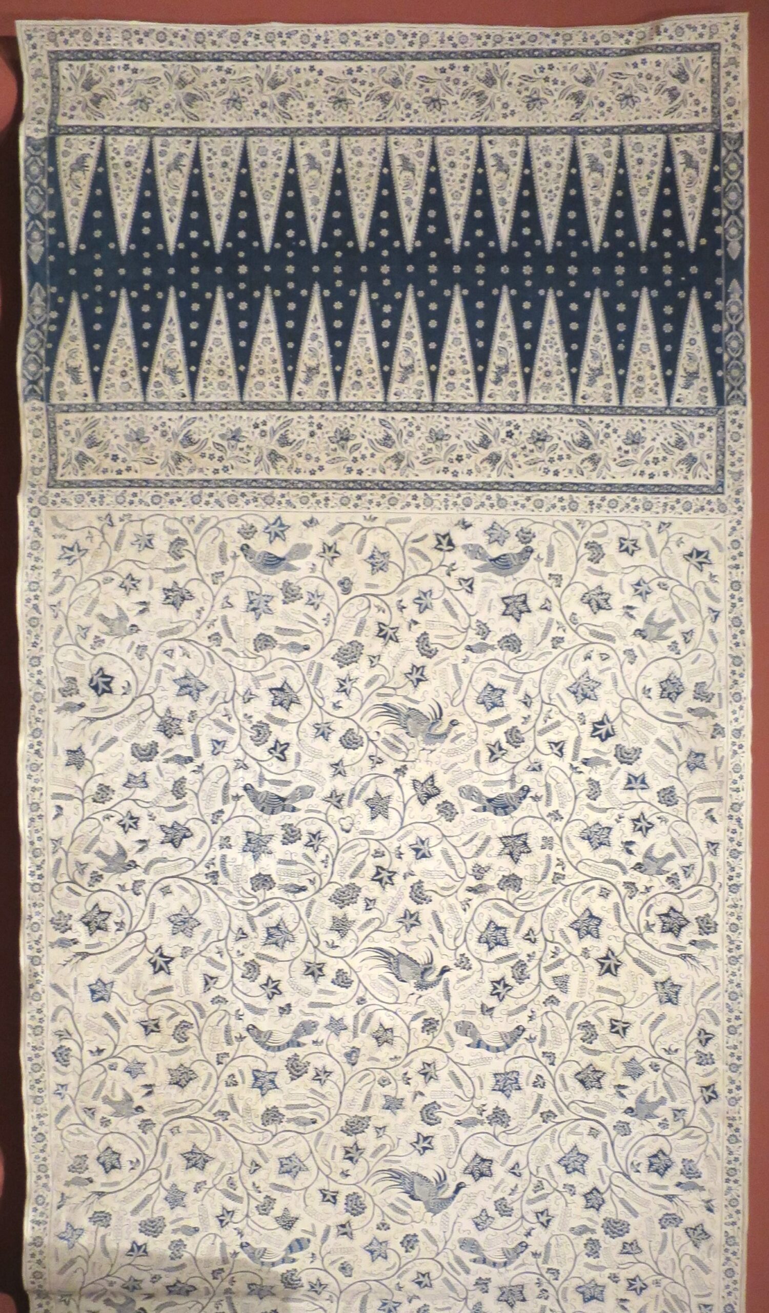 Blue and cream cotton tulis batik sarong from Cirebon, with birds, flowers and a triangular head panel.